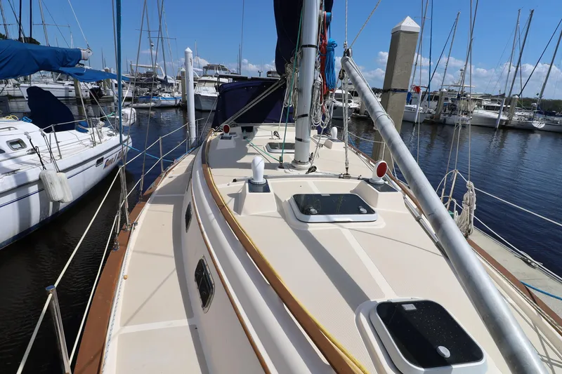 Slide: The Image of 1996 Island Packet 40 sailboat docked at marina, showcasing deck and rigging. - 42