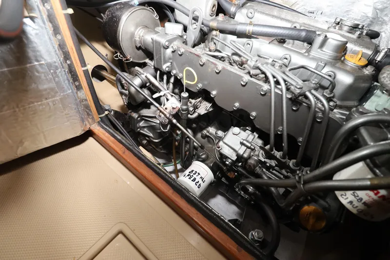 Slide: The Image of Engine compartment of a 1996 Island Packet 40 sailboat, showcasing mechanical components. - 44