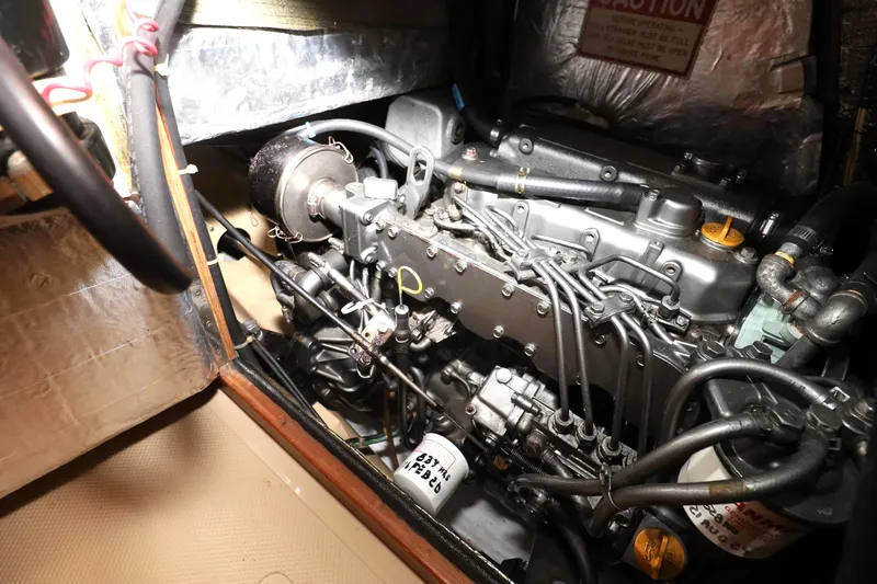 Slide: The Image of Engine compartment of a 1996 Island Packet 40 sailboat, showcasing detailed mechanical components. - 45