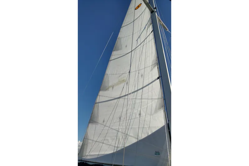 Slide: The Image of Sail of a 1996 Island Packet 40 yacht against a clear blue sky. - 48
