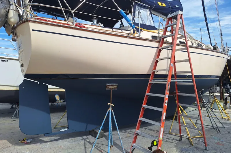 Slide: The Image of 1996 Island Packet 40 sailboat on dry dock with ladder and supports. - 50