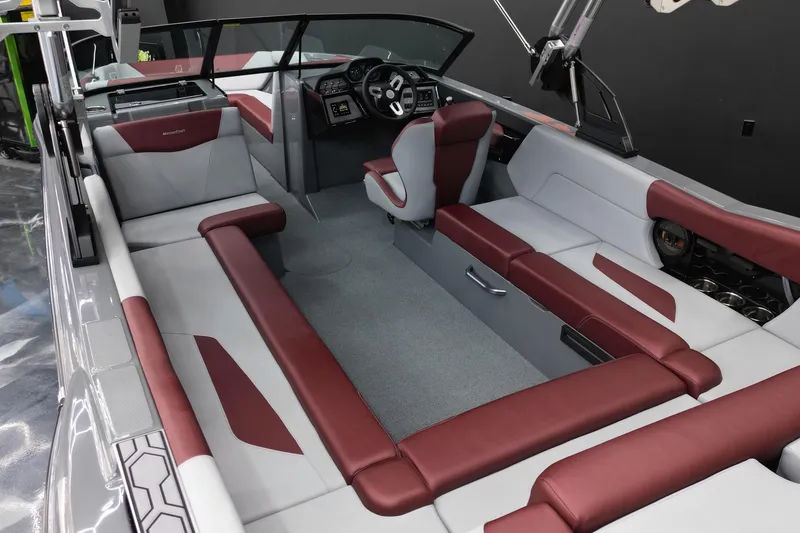 Slide: The Image of 2023 MasterCraft NXT24 boat interior with red and gray seating, modern dashboard. - 12