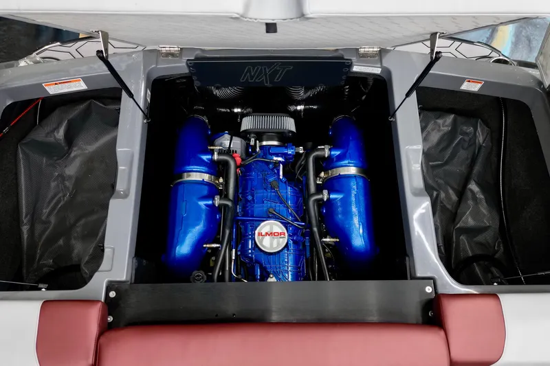 Slide: The Image of 2023 MasterCraft NXT24 engine compartment with blue Ilmor engine components. - 13