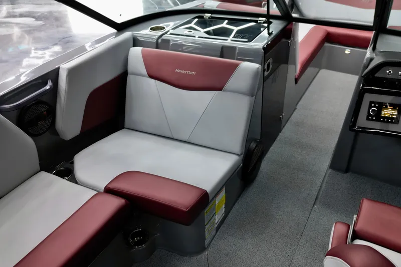 Slide: The Image of 2023 MasterCraft NXT24 interior with red and gray seating, modern design. - 14