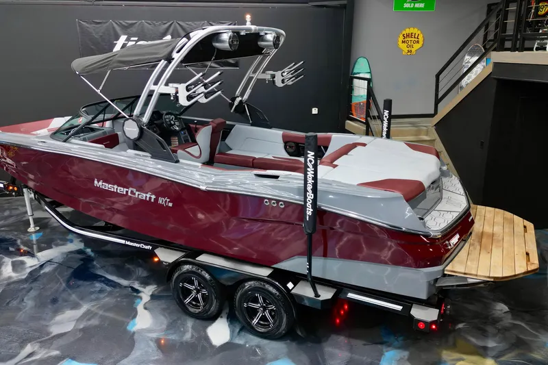 Slide: The Image of 2023 MasterCraft NXT24 boat in showroom, featuring sleek design and modern amenities. - 3