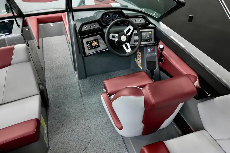 Slide: The Image of 2023 MasterCraft NXT24 boat interior with red and white seating, modern dashboard, and steering wheel. - 7