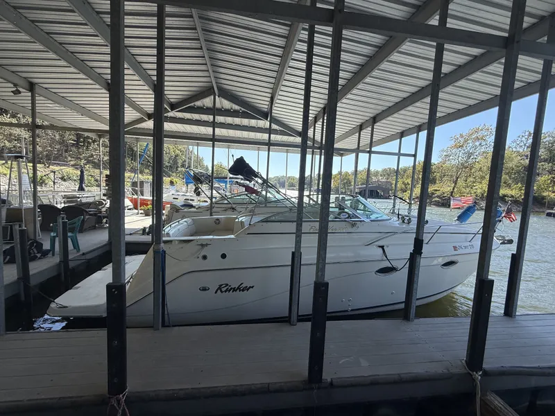 Slide: The Image of 2000 Rinker Fiesta Vee 270 boat docked under a covered marina. - 14