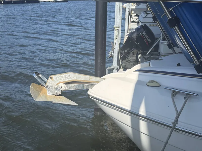 Slide: The Image of 2000 Rinker Fiesta Vee 270 boat with anchor by the water. - 16