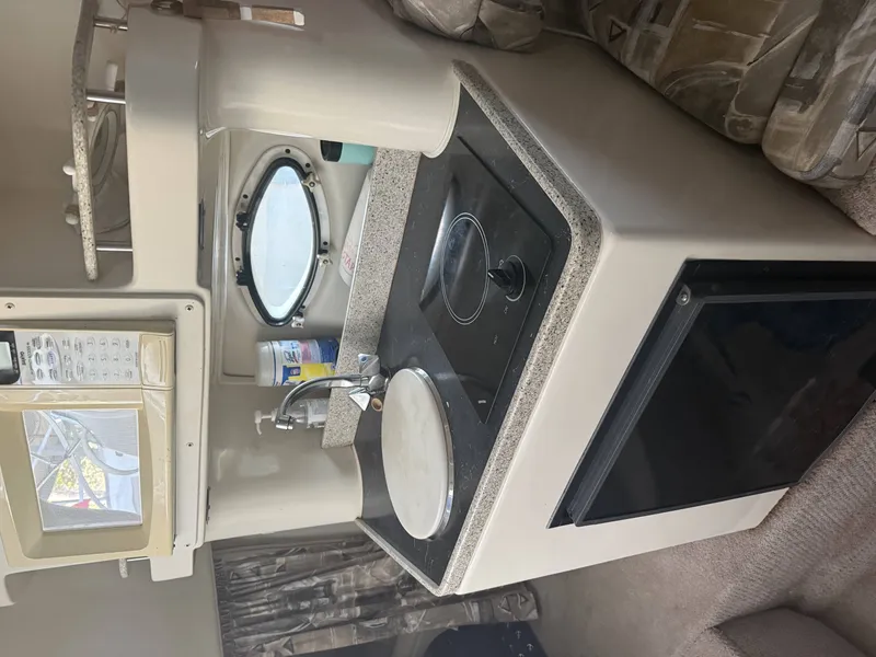 Slide: The Image of Interior of 2000 Rinker Fiesta Vee 270 yacht kitchen. - 7