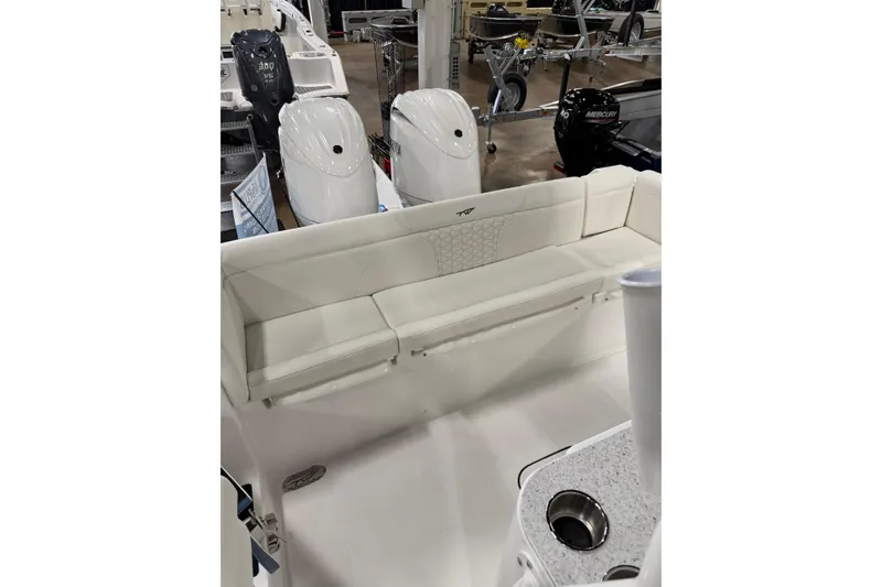 Slide: The Image of 2026 Tidewater 272 LXF boat interior with white seating and dual outboard motors. - 3