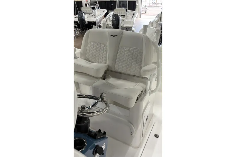 Slide: The Image of 2026 Tidewater 272 LXF boat interior with luxurious seating and steering wheel. - 4