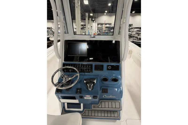 Slide: The Image of 2026 Tidewater 272 LXF boat dashboard with steering wheel and control panel. - 5