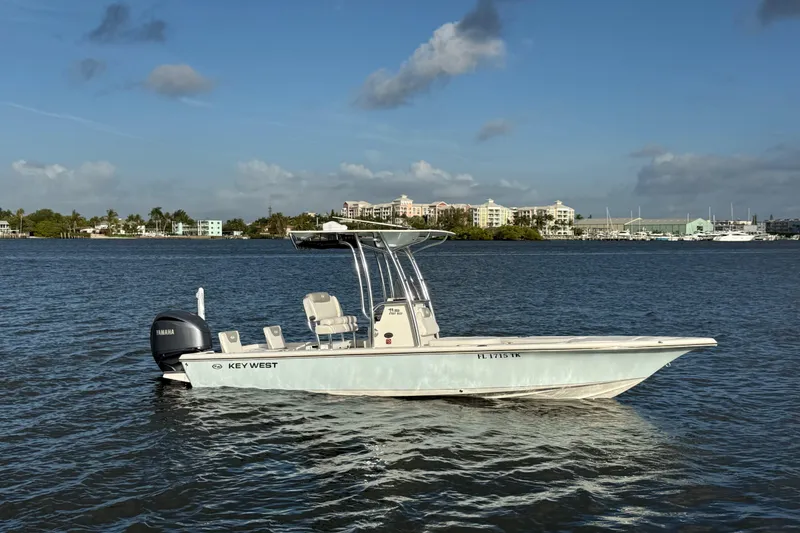The Image of 2023 Key West 250 Bay Reef boat on calm water, clear sky background. - 1