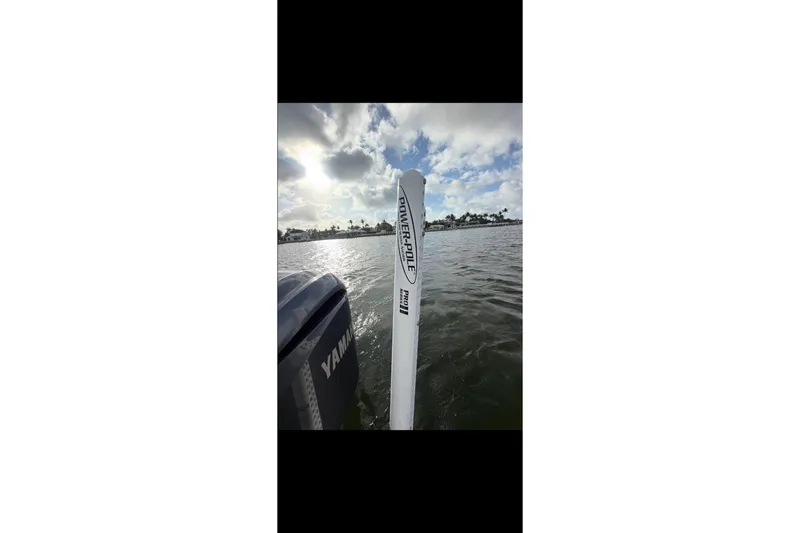 Slide: The Image of 2023 Key West 250 Bay Reef boat with Yamaha engine on a sunny day. - 16