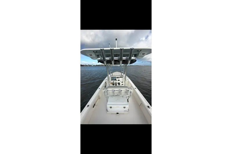 Slide: The Image of 2023 Key West 250 Bay Reef boat on calm water, featuring a sleek center console design. - 17