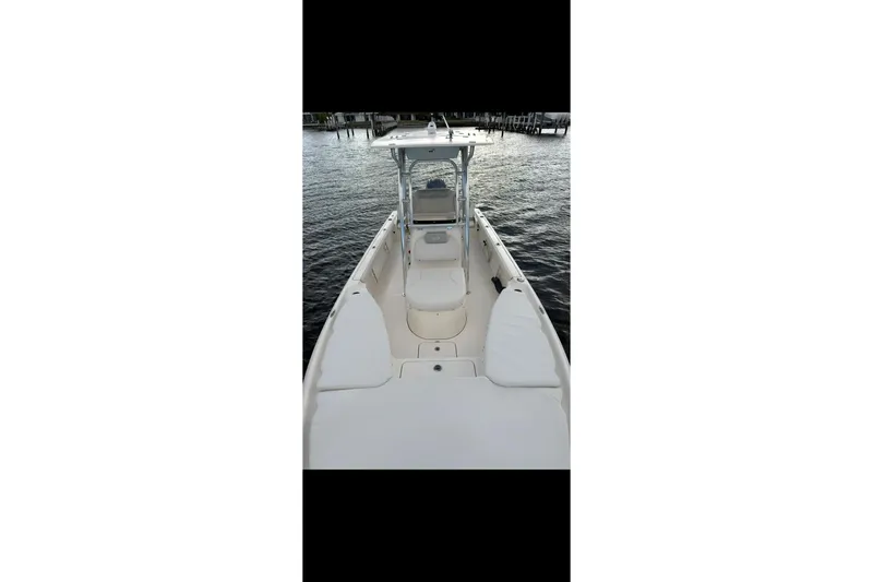 Slide: The Image of 2023 Key West 250 Bay Reef boat on water, showcasing spacious deck and seating. - 4