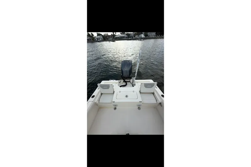 Slide: The Image of 2023 Key West 250 Bay Reef boat on water, rear view with motor. - 8
