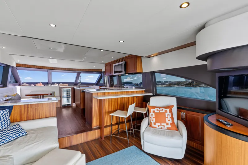 Slide: The Image of Luxurious interior of 2013 Hatteras 60 Motor Yacht with modern furnishings and panoramic windows. - 11