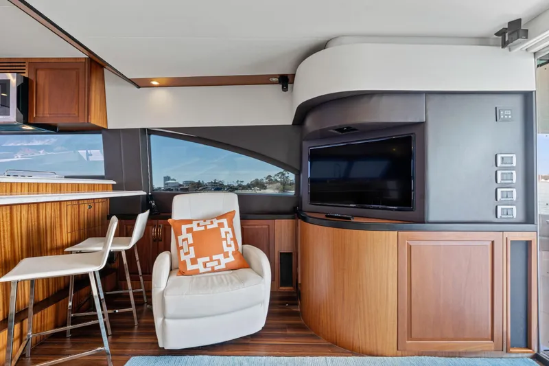 Slide: The Image of Luxurious interior of 2013 Hatteras 60 Motor Yacht with modern seating and entertainment area. - 12