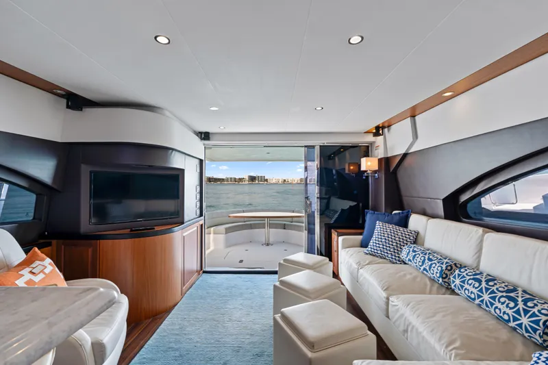 Slide: The Image of Luxurious interior of 2013 Hatteras 60 Motor Yacht with elegant seating and waterfront view. - 13