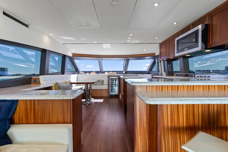 Slide: The Image of Luxurious interior of 2013 Hatteras 60 Motor Yacht with modern kitchen and panoramic windows. - 16