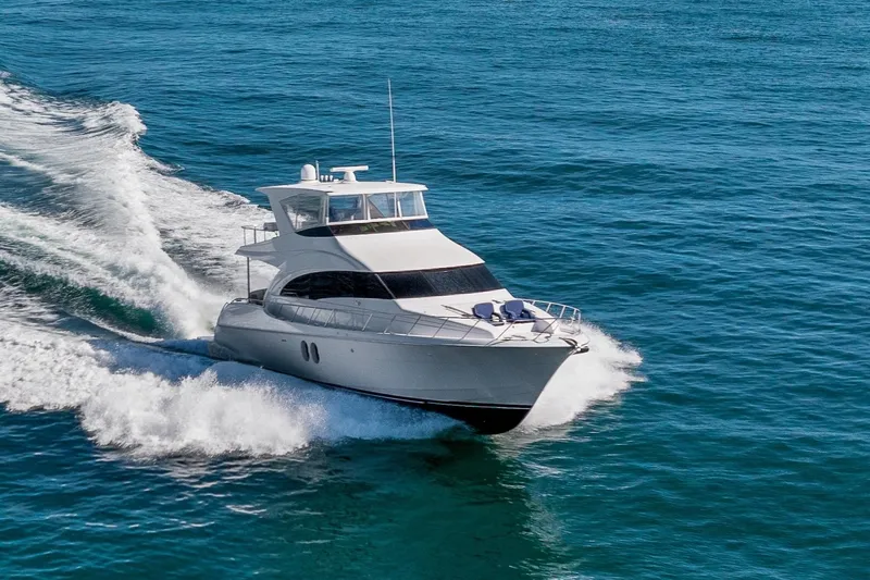 Slide: The Image of 2013 Hatteras 60 Motor Yacht cruising on open blue waters. - 2