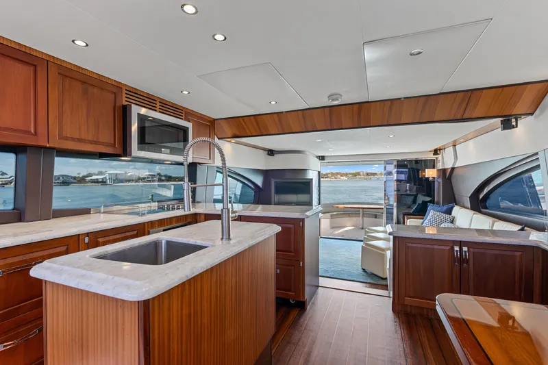 Slide: The Image of Luxurious interior of 2013 Hatteras 60 Motor Yacht with modern kitchen and scenic views. - 20