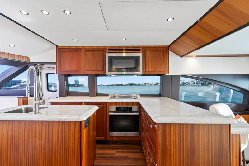 Slide: The Image of Luxurious kitchen interior of 2013 Hatteras 60 Motor Yacht with wood cabinetry and ocean view. - 21