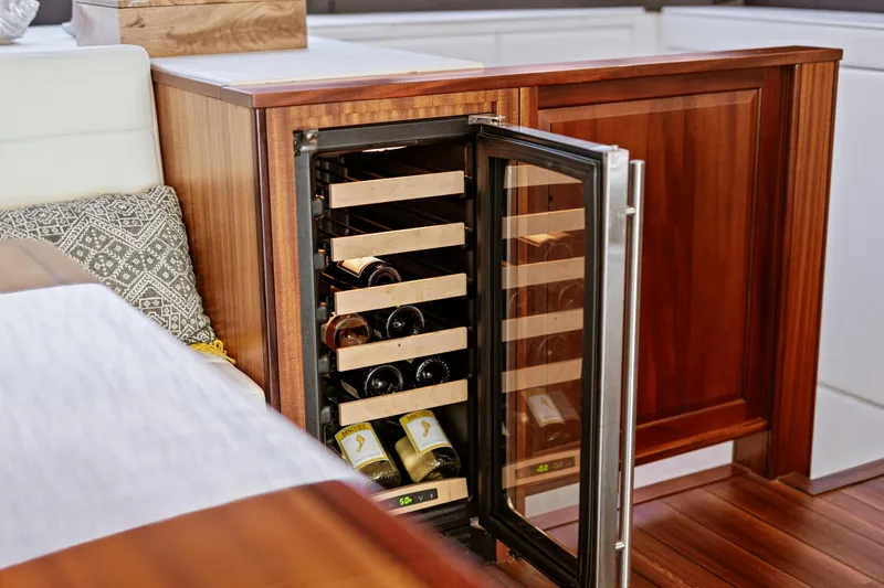Slide: The Image of Wine cooler in 2013 Hatteras 60 Motor Yacht interior with wooden cabinetry. - 23