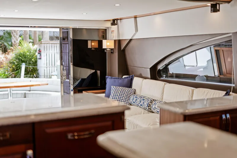 Slide: The Image of Luxurious interior of 2013 Hatteras 60 Motor Yacht with elegant seating and decor. - 25