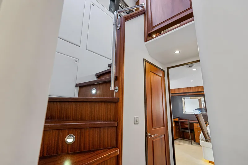 Slide: The Image of Interior of 2013 Hatteras 60 Motor Yacht with wooden stairs and modern design. - 27