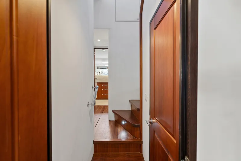 Slide: The Image of Interior hallway of 2013 Hatteras 60 Motor Yacht with wooden doors and stairs. - 28