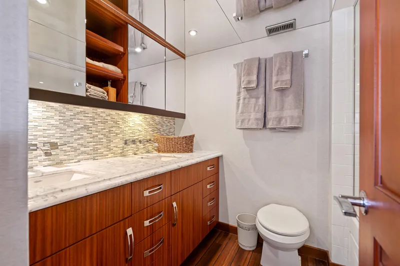 Slide: The Image of Luxurious bathroom in 2013 Hatteras 60 Motor Yacht with modern fixtures and elegant wood cabinetry. - 39