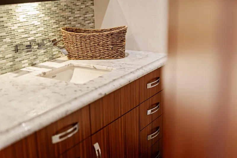 Slide: The Image of Luxurious bathroom interior of 2013 Hatteras 60 Motor Yacht with marble countertop and wicker basket. - 40