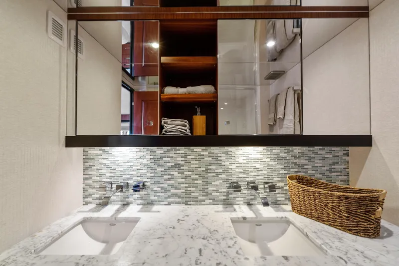 Slide: The Image of Luxurious bathroom in 2013 Hatteras 60 Motor Yacht with dual sinks and elegant tile backsplash. - 42