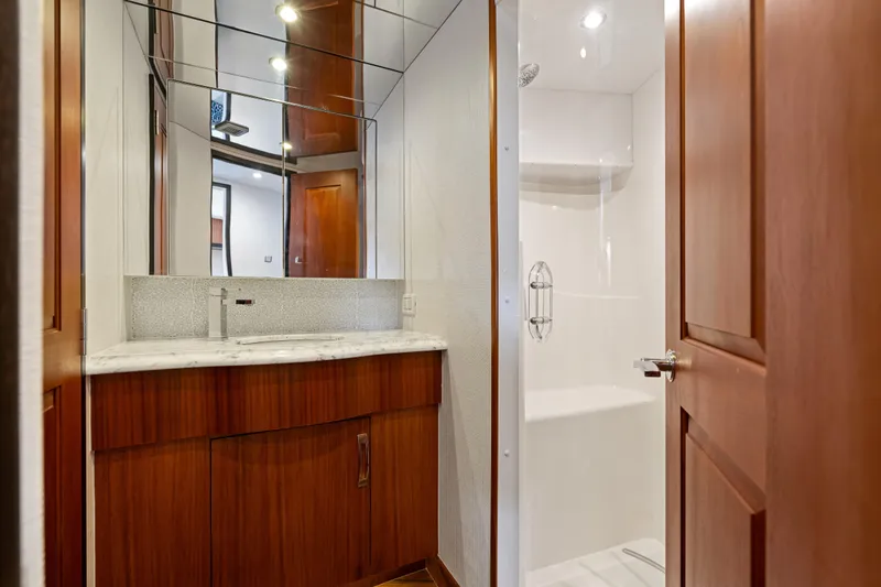 Slide: The Image of Luxurious bathroom interior of 2013 Hatteras 60 Motor Yacht with wood cabinetry and marble countertop. - 46