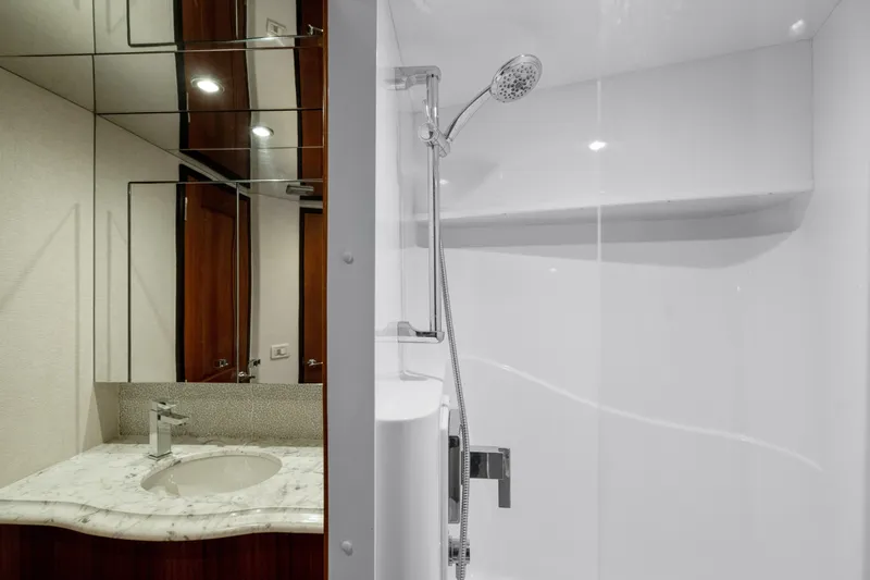 Slide: The Image of Luxurious bathroom in 2013 Hatteras 60 Motor Yacht with marble sink and modern shower. - 48