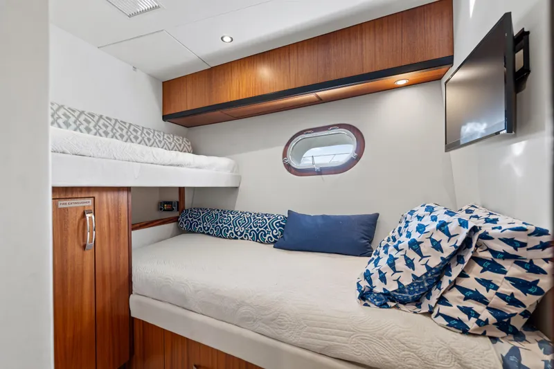 Slide: The Image of Cozy cabin interior of 2013 Hatteras 60 Motor Yacht with bunk beds and nautical decor. - 49