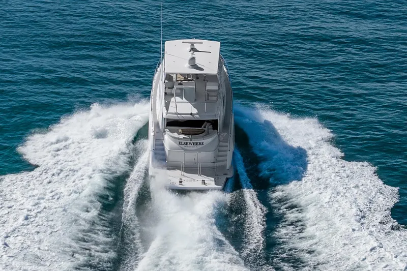 Slide: The Image of 2013 Hatteras 60 Motor Yacht cruising on open water, rear view. - 5