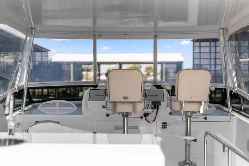 Slide: The Image of 2013 Hatteras 60 Motor Yacht helm with dual seats and navigation equipment. - 53