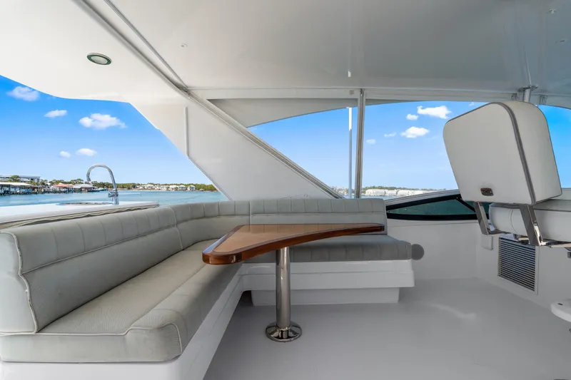 Slide: The Image of Luxurious interior of 2013 Hatteras 60 Motor Yacht with elegant seating and scenic views. - 54