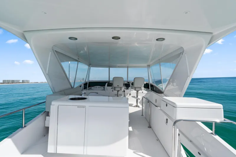 Slide: The Image of 2013 Hatteras 60 Motor Yacht flybridge with ocean view and seating area. - 59