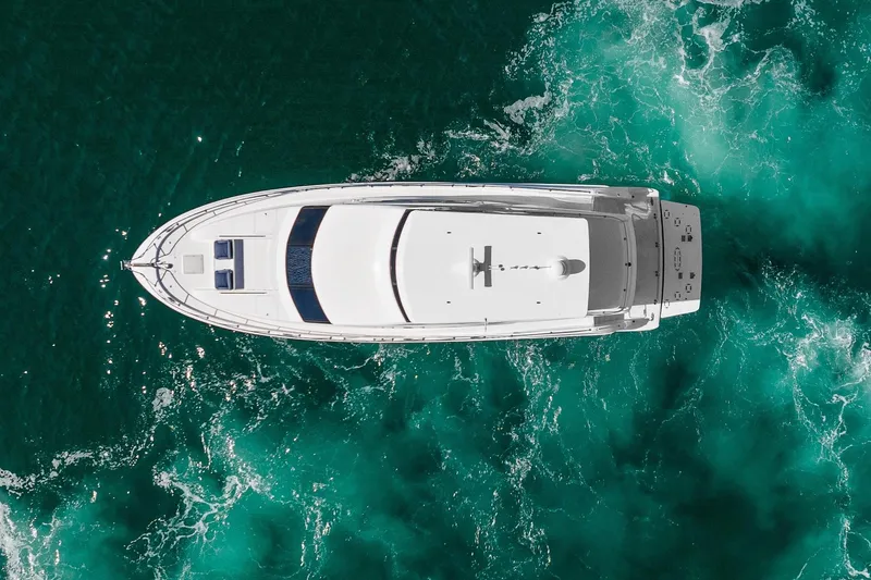 Slide: The Image of Aerial view of 2013 Hatteras 60 Motor Yacht cruising in turquoise waters. - 6