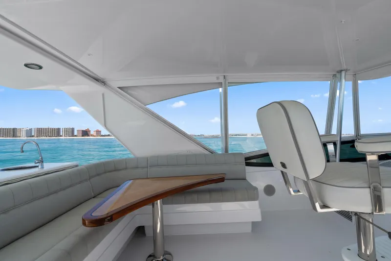Slide: The Image of Luxurious interior of 2013 Hatteras 60 Motor Yacht with ocean view and seating area. - 60