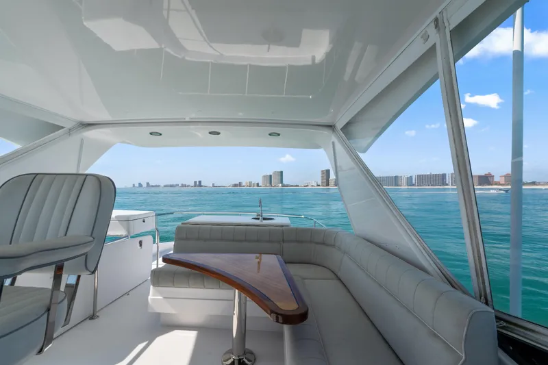 Slide: The Image of Luxurious 2013 Hatteras 60 Motor Yacht interior with ocean view and city skyline. - 61