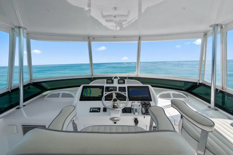 Slide: The Image of Helm of 2013 Hatteras 60 Motor Yacht with ocean view and navigation equipment. - 63