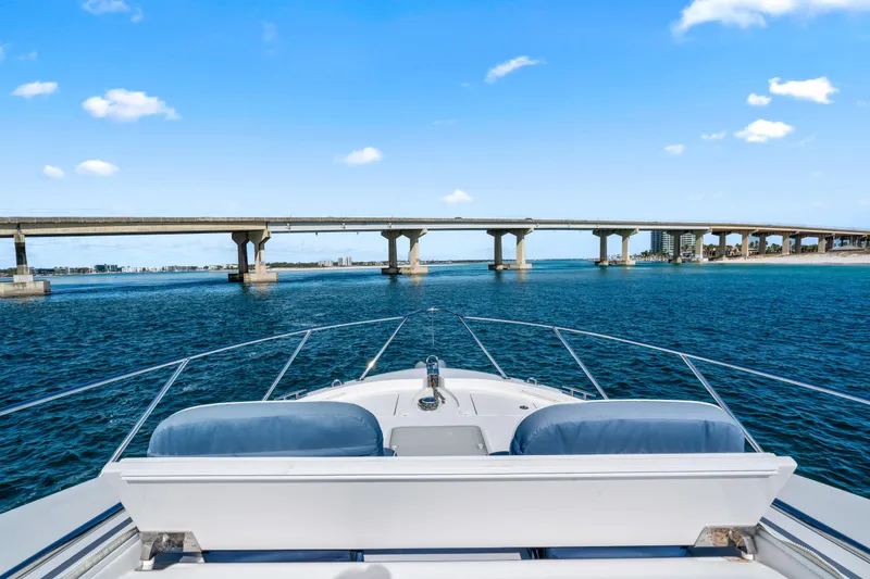 Slide: The Image of 2013 Hatteras 60 Motor Yacht cruising under a bridge on a sunny day. - 70