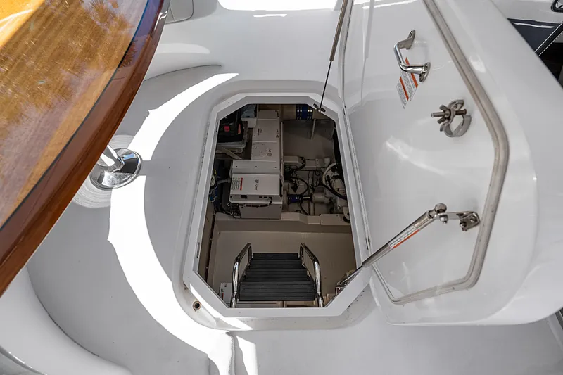 Slide: The Image of Engine room access on 2013 Hatteras 60 Motor Yacht, featuring open hatch and visible equipment. - 71