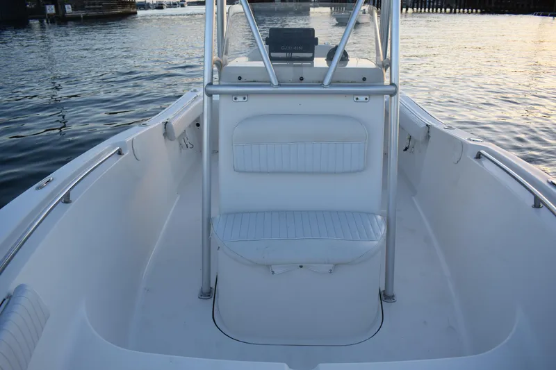 Slide: The Image of 2007 Tidewater 216 CC Adventure boat interior with seating, on calm water. - 10