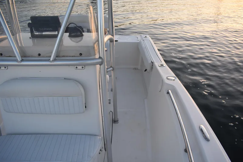 Slide: The Image of 2007 Tidewater 216 CC Adventure boat interior with seating and railing, on calm water. - 12